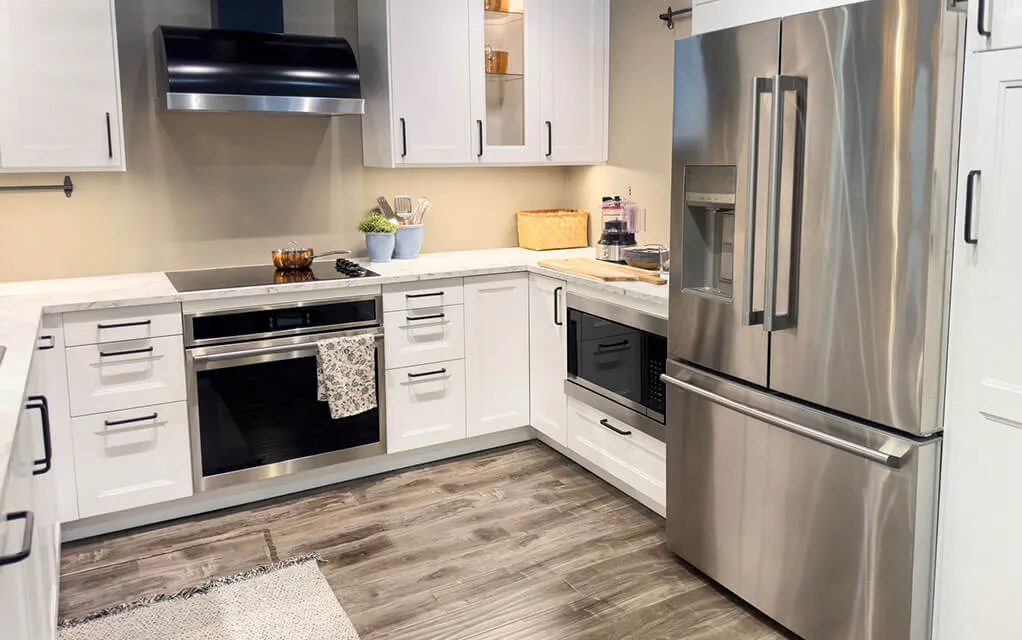 View of a nice modern home kitchen, with a number of stainless steel appliances and a clean look.