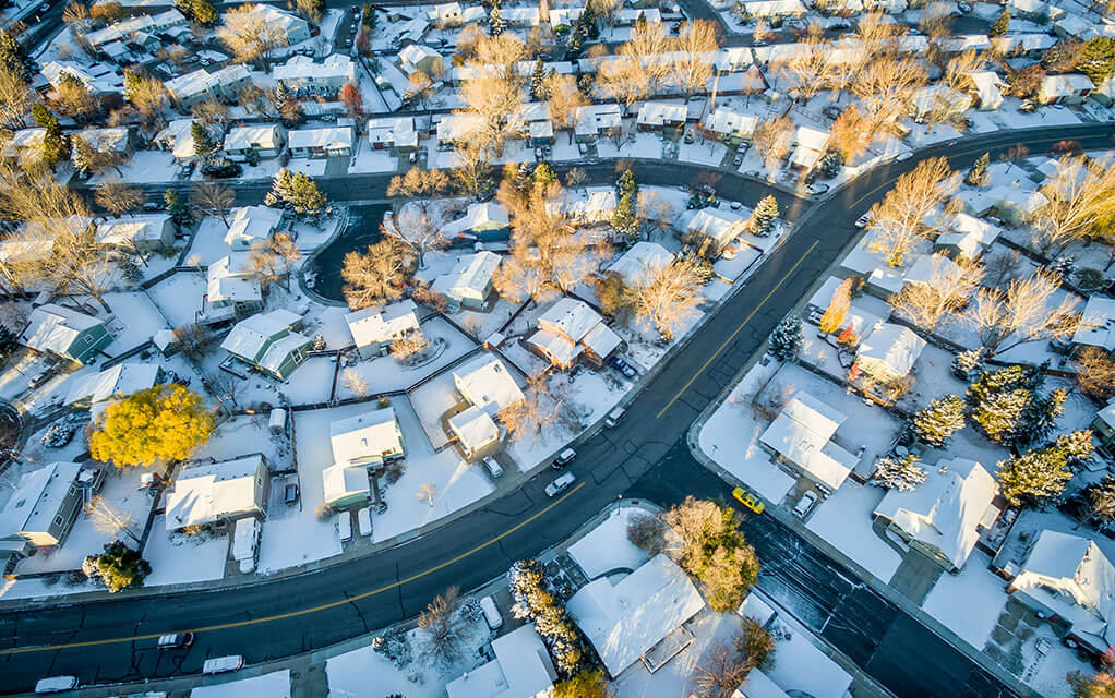 Overhead view of a suburban neighborhood the morning after a heavy snowfall