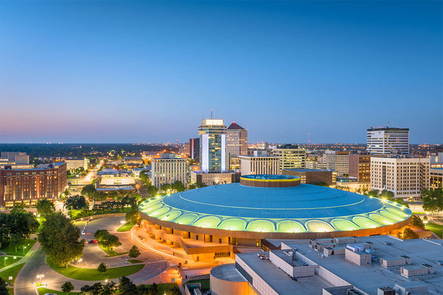 An aerial view of the downtown Wichita skyline at dusk on a clear night
