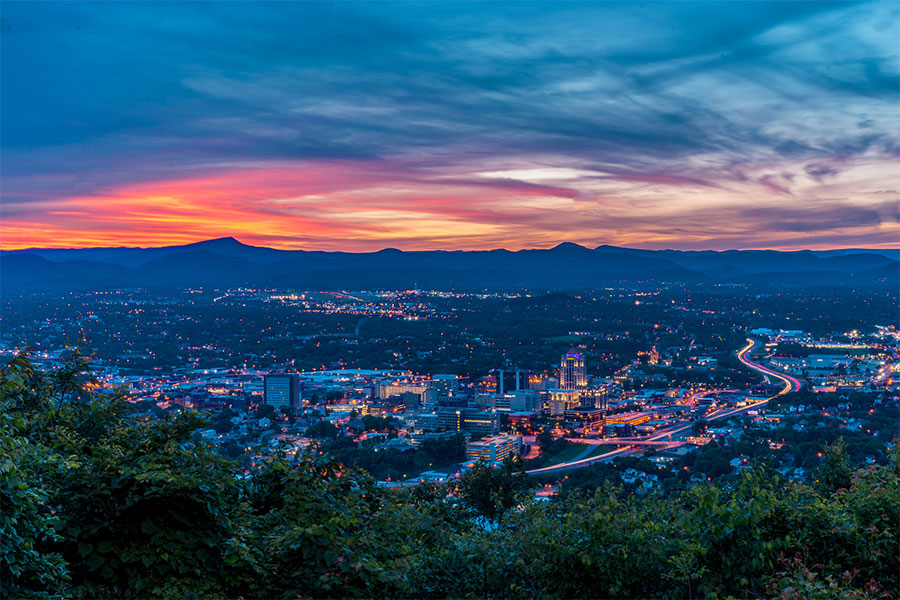 A view of the city of Roanoke, VA as the sun sets in the background